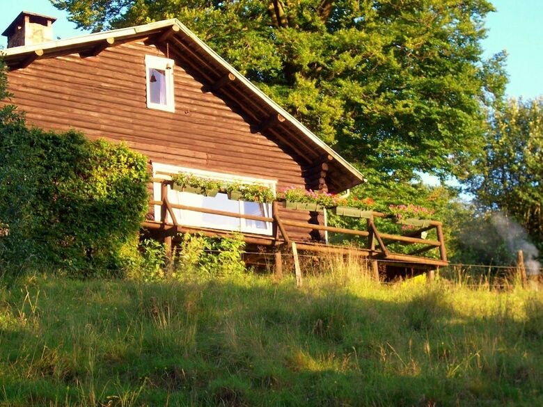 Open Wooden Chalet Built Against A Hill