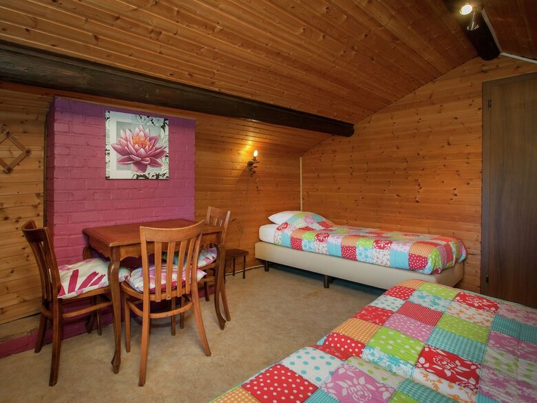Open Wooden Chalet Built Against A Hill